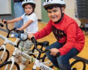 Students at Fruit Valley Elementary School get ready to ride a bike.